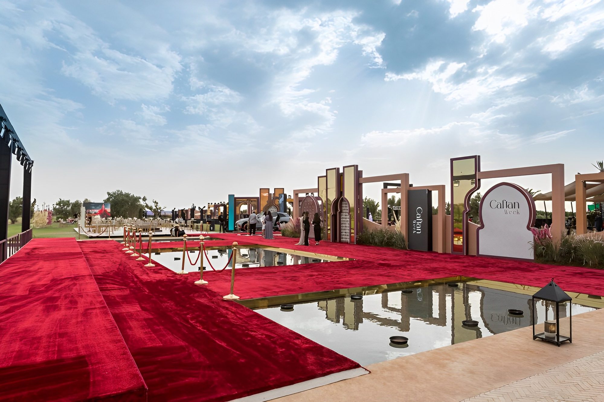 Caftan Week 2024 event setting in Marrakech with red carpet, reflecting pool and patterned arches